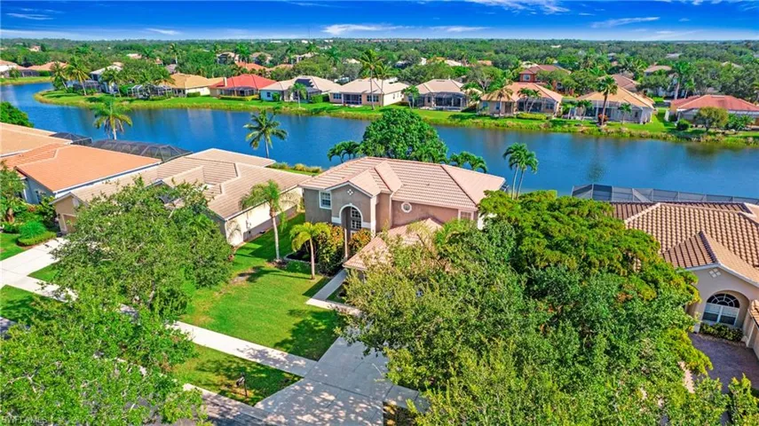 Aerial perspective of suburban area with a nearby body of water