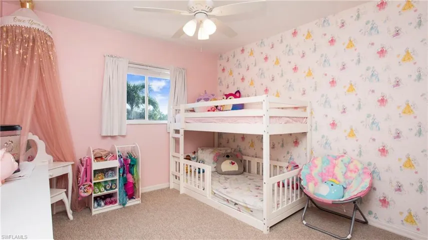 Bedroom featuring carpet floors, wallpapered walls, and ceiling fan