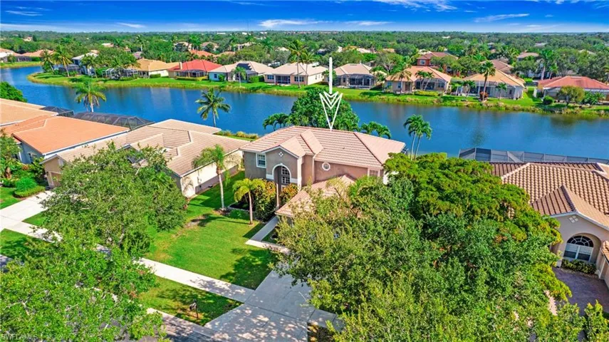 Aerial view of residential area featuring a nearby body of water