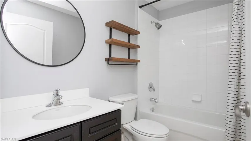 Full bath featuring shower / bathtub combination with curtain and vanity