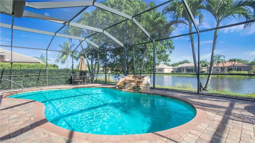 View of swimming pool with a water view, a patio area, and a lanai