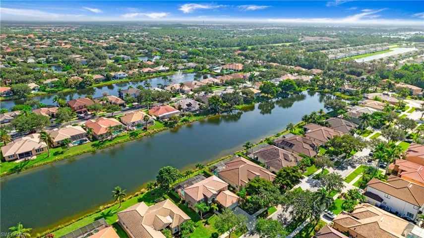 Aerial perspective of suburban area featuring a large body of water