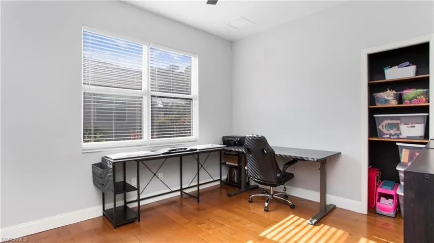 Office space featuring wood finished floors and baseboards