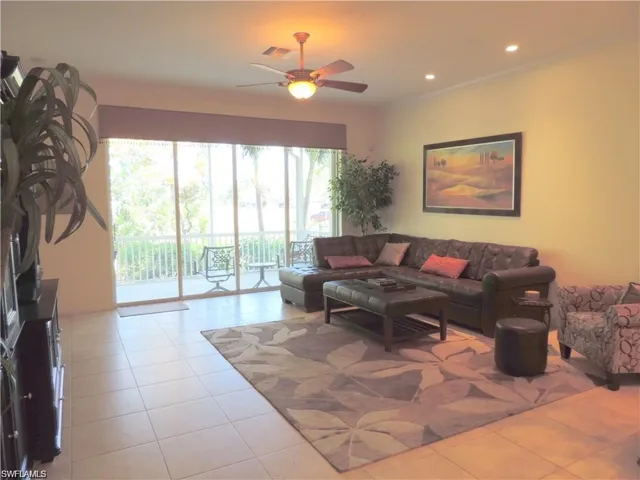 Tiled living room featuring ceiling fan