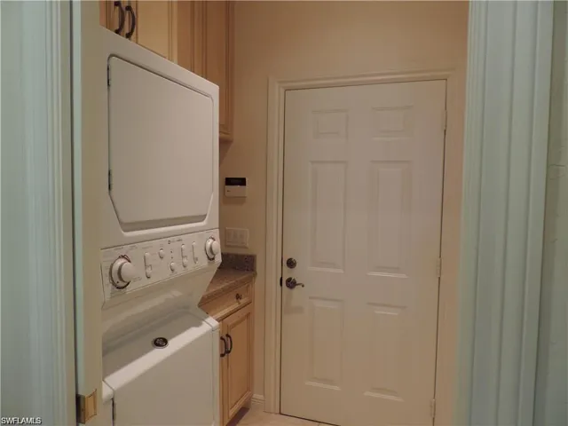 Laundry area featuring stacked washer and clothes dryer