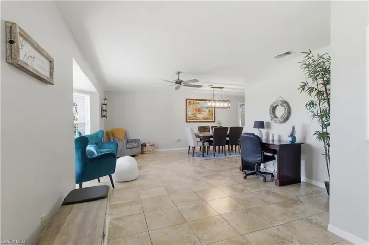 Office space featuring light tile patterned floors and ceiling fan