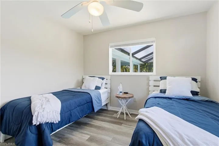 Bedroom with wood finished floors and a ceiling fan