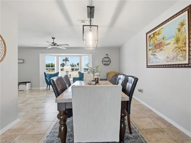 Dining space featuring a ceiling fan and light tile patterned floors