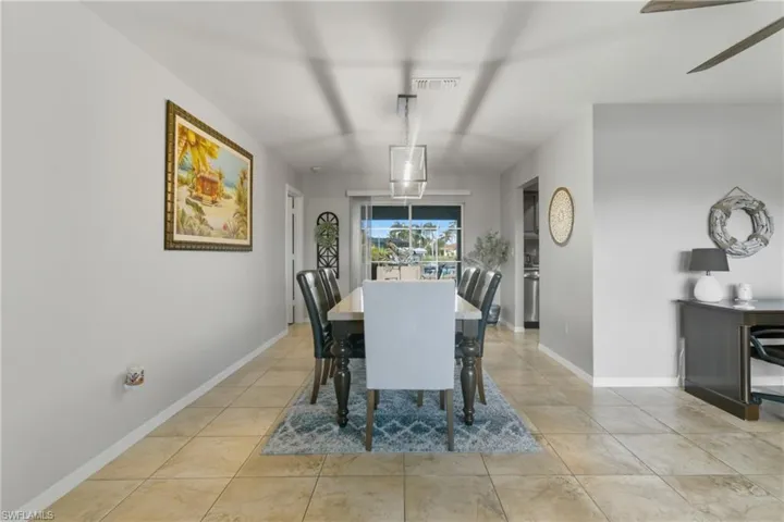 Dining space featuring light tile patterned floors and ceiling fan
