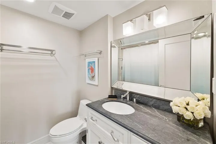 Full bath with toilet, vanity, and a shower with curtain