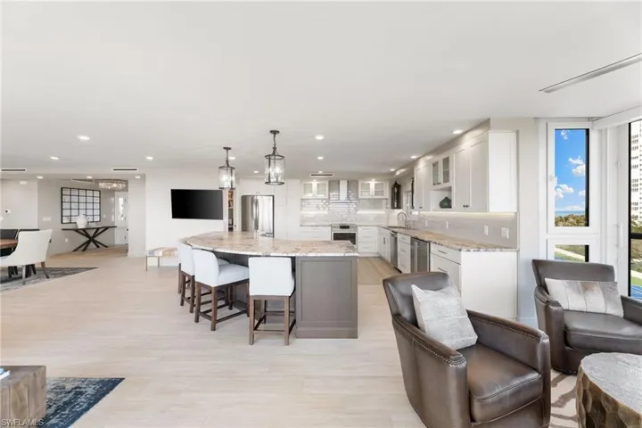 Kitchen featuring appliances with stainless steel finishes, a sink, white cabinets, recessed lighting, and glass insert cabinets