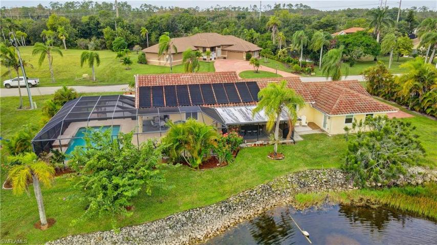 Rear aerial view of the home with solar panels to heat the pool.