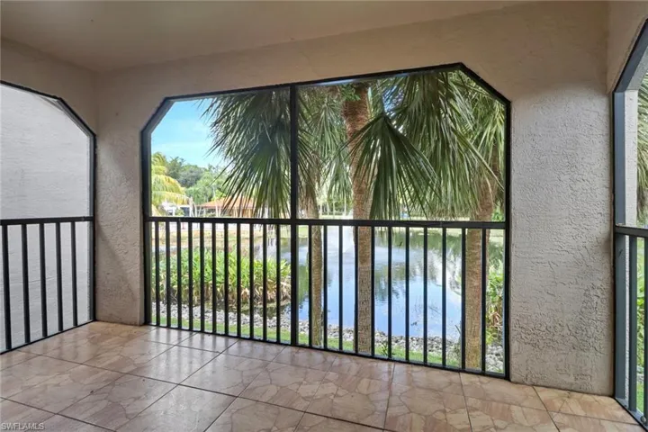Unfurnished sunroom featuring a water view
