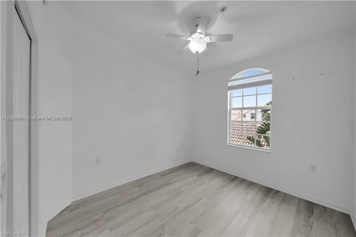 Spare room featuring a ceiling fan and light wood-style flooring