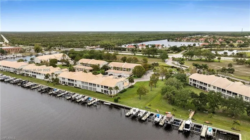 Drone / aerial view of a nearby body of water and numerous boat docks