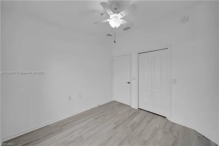 Unfurnished bedroom featuring light wood-style flooring, a ceiling fan, and a closet