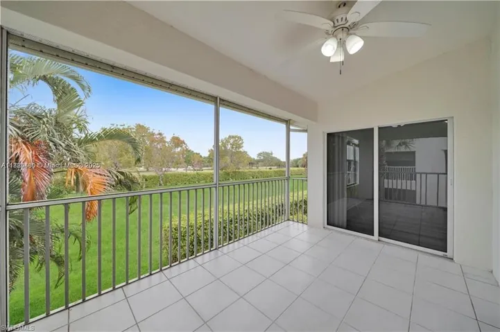 Unfurnished sunroom featuring lofted ceiling and tile patterned flooring