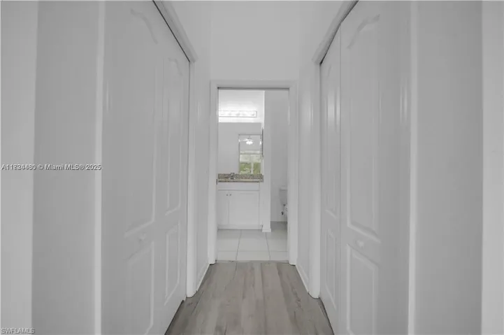 Hallway featuring light wood finished floors