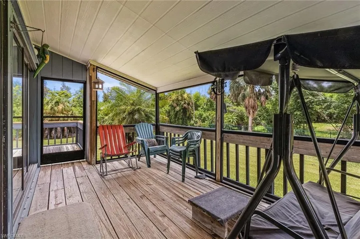 Unfurnished sunroom featuring lofted ceiling