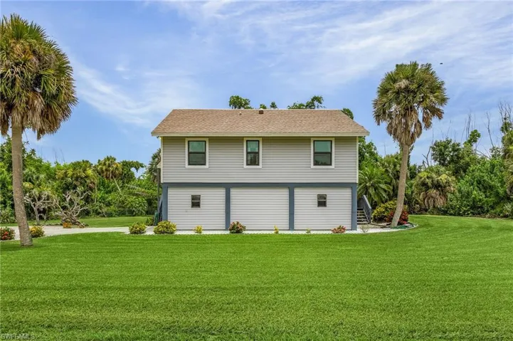 Rear view of house with a lawn