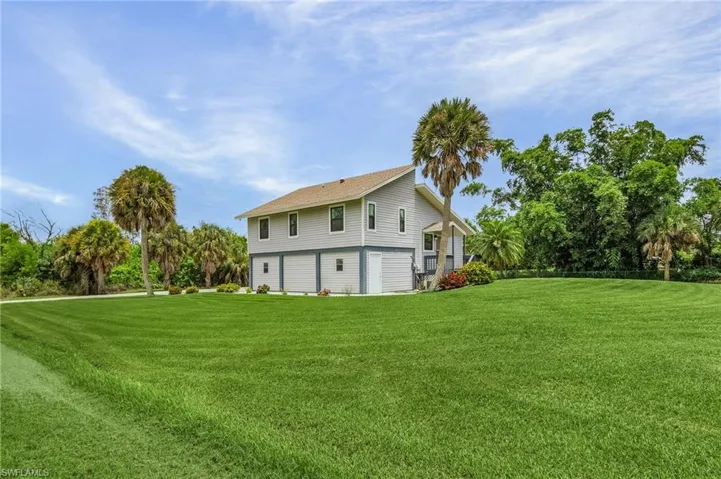 View of home's exterior with a yard
