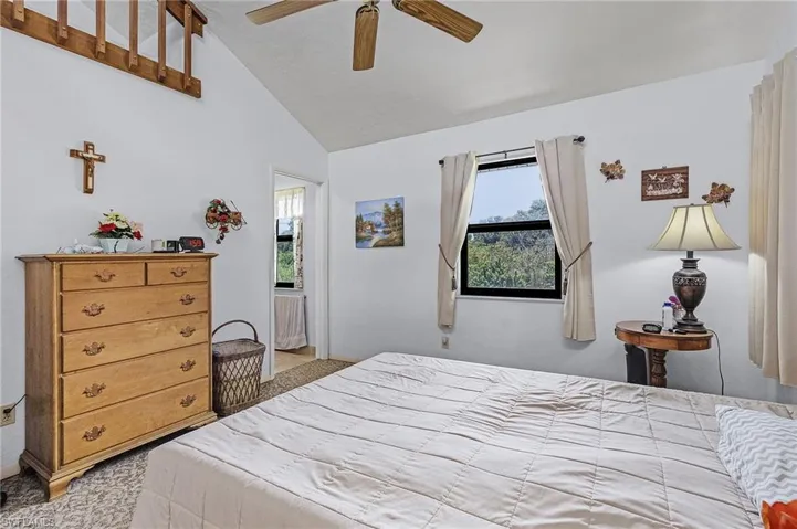 Bedroom with lofted ceiling and ceiling fan