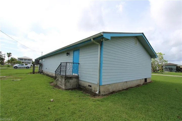 View of side of property featuring a yard