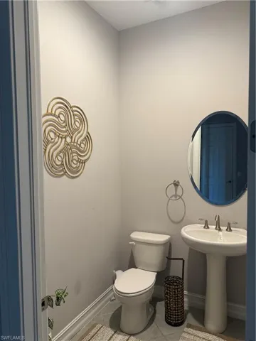 Bathroom featuring baseboards and light tile patterned floors