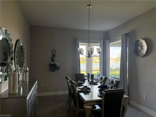 Dining space featuring a water view and a chandelier