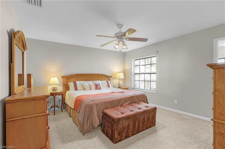 Carpeted bedroom with ceiling fan