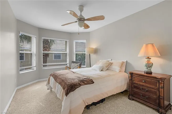 Bedroom featuring ceiling fan and light carpet