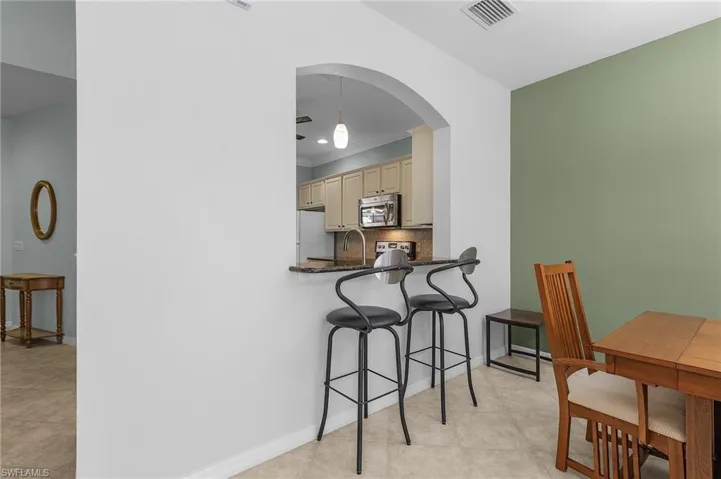 Dining room with sink and ornamental molding