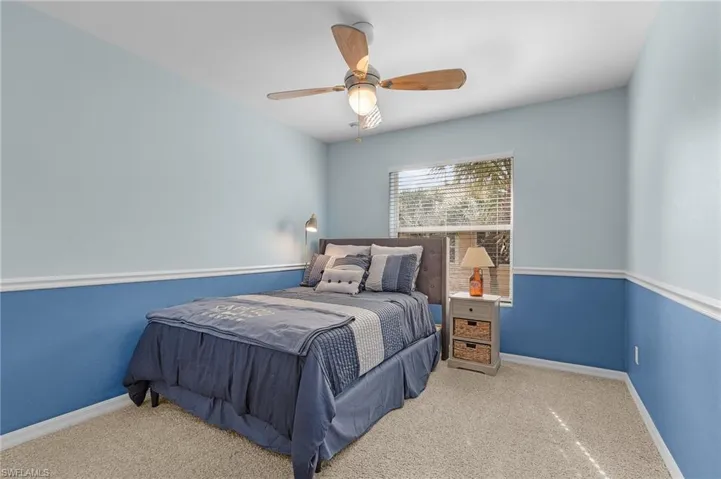 Carpeted bedroom with ceiling fan