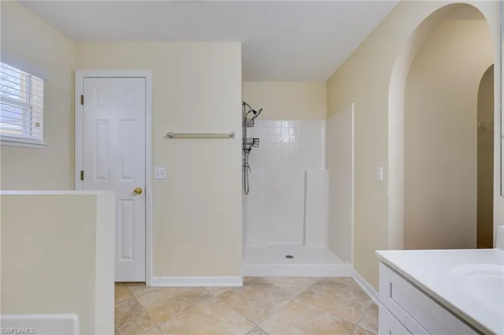 Full bathroom featuring a shower stall and vanity