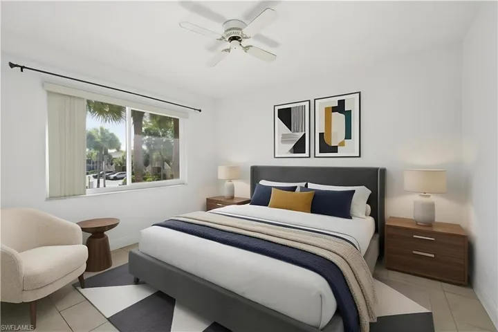 Bright bedroom featuring a large window, ceiling fan, and tile flooring