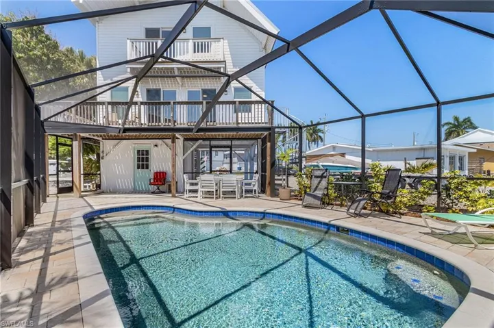Newer screened heated pool and storage shed on the ground level.