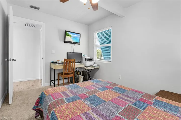 Guest Bedroom has impact windows and Bahama shutters.