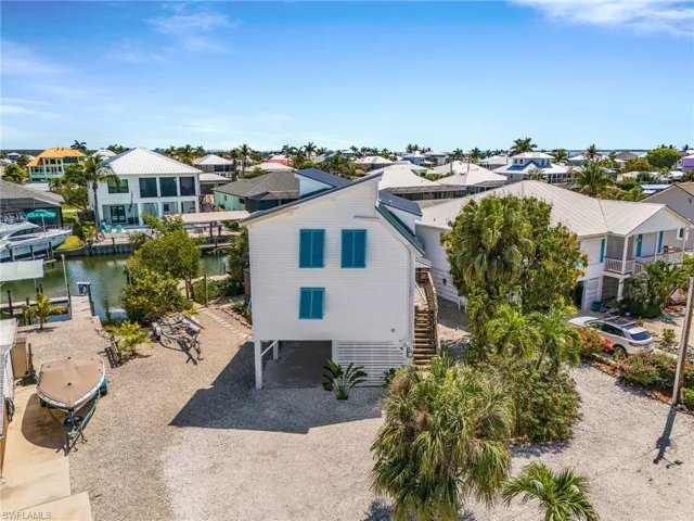 Aerial of the front of the home and maintenance-free property.