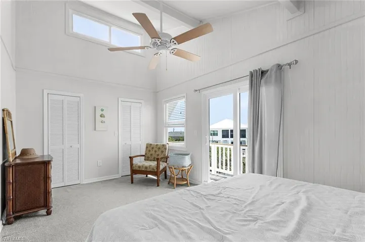 The primary bedroom has a vaulted ceiling with additional window for extra lighting, impact windows and slider, and a large walk-in closet.