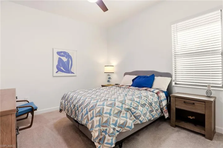 Bedroom featuring light colored carpet and ceiling fan