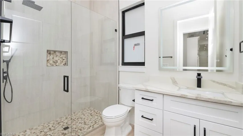 Bathroom featuring a stall shower and vanity