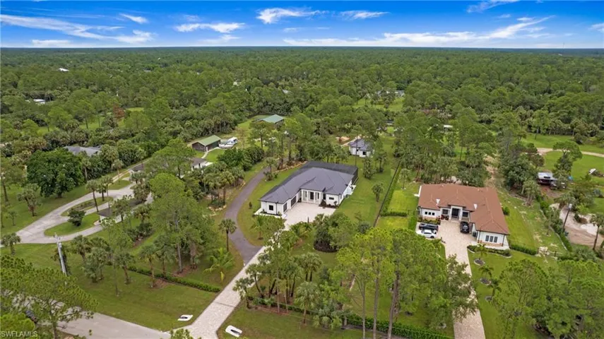 Aerial view of property's location featuring a forest