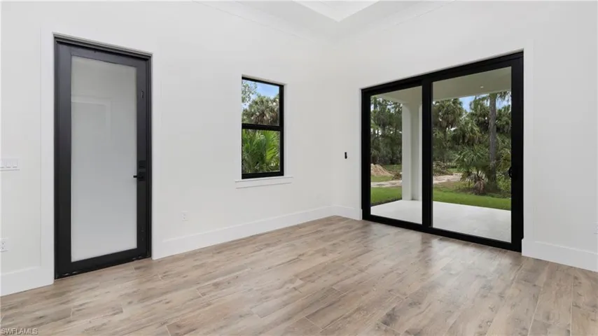 Unfurnished room with light wood-type flooring and crown molding