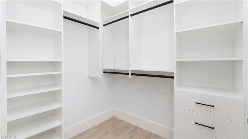 Walk in closet featuring light wood finished floors