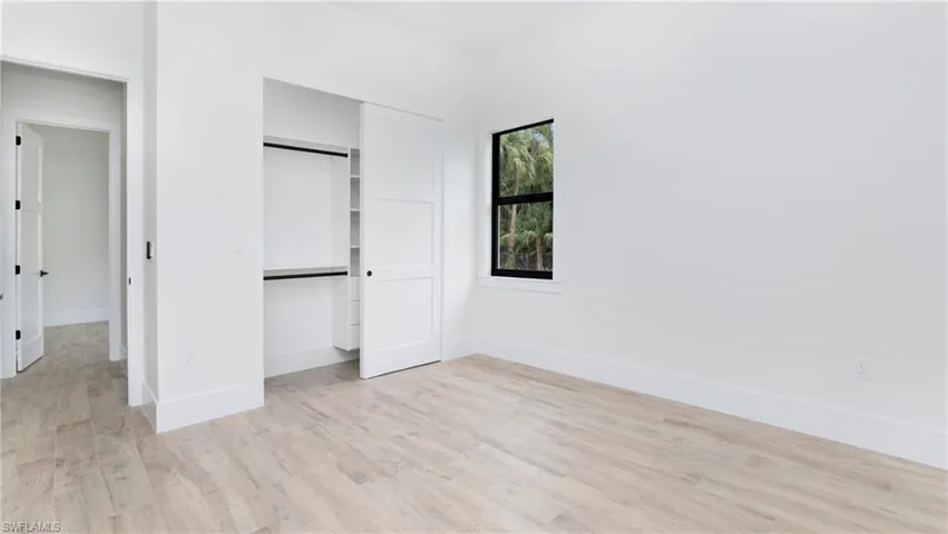 Unfurnished bedroom featuring light wood-type flooring and a closet