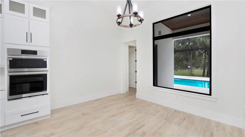 Unfurnished dining area featuring light wood-style floors and a chandelier