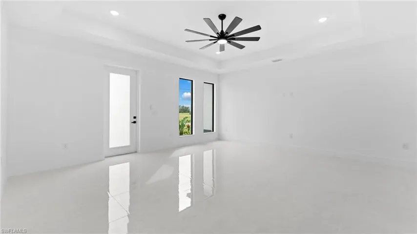 Spare room featuring a tray ceiling and ceiling fan