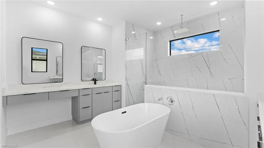 Bathroom featuring tile patterned flooring, vanity, and independent shower and bath