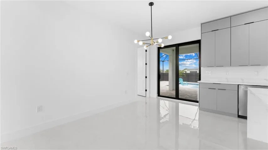 Unfurnished dining area featuring a notable chandelier