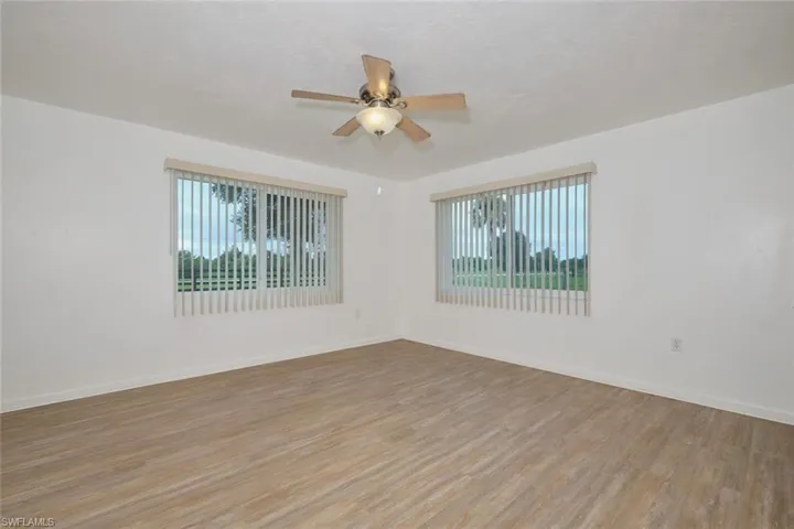 Spare room with light wood-type flooring and ceiling fan